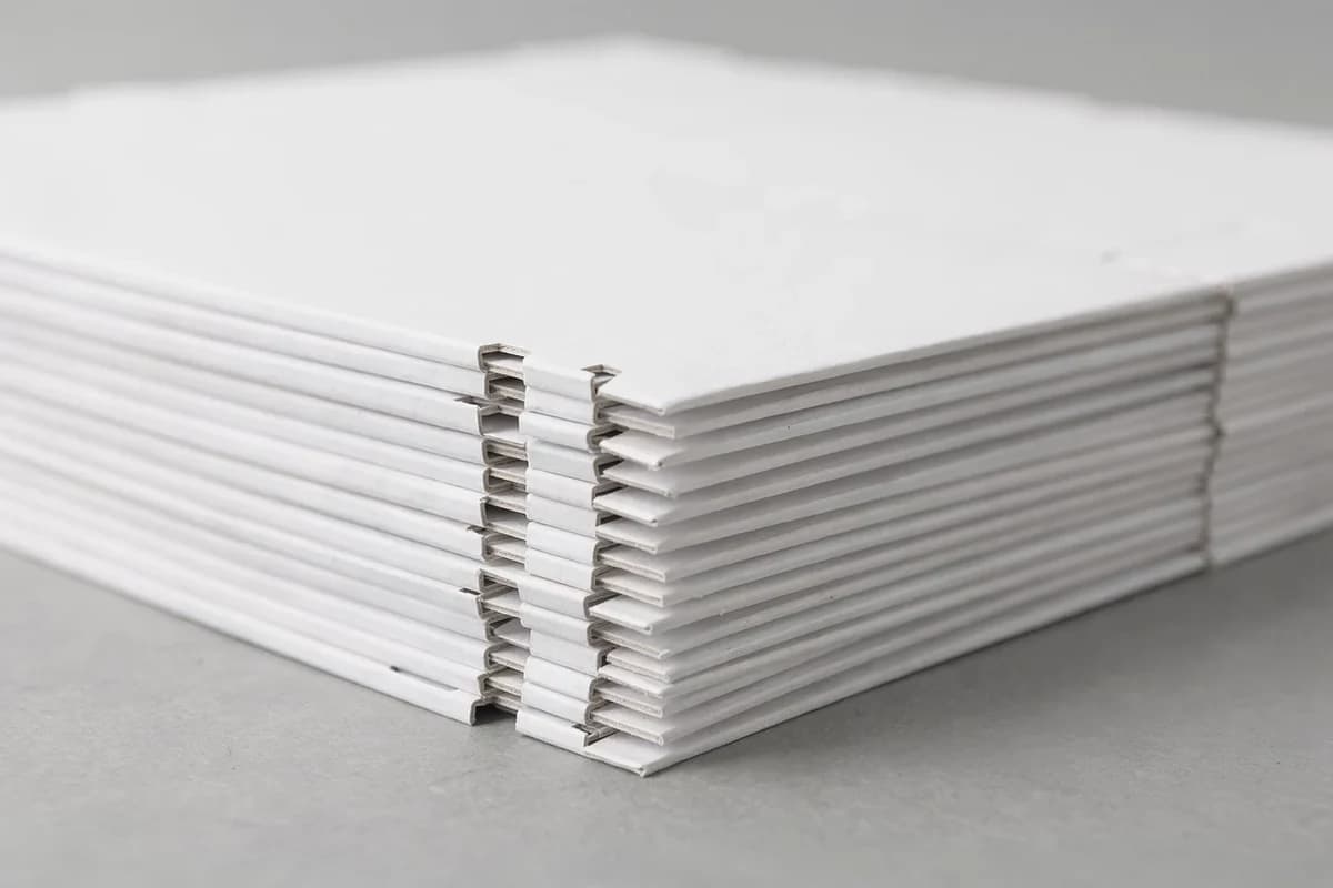 A stack of cut and creased folding carton blanks