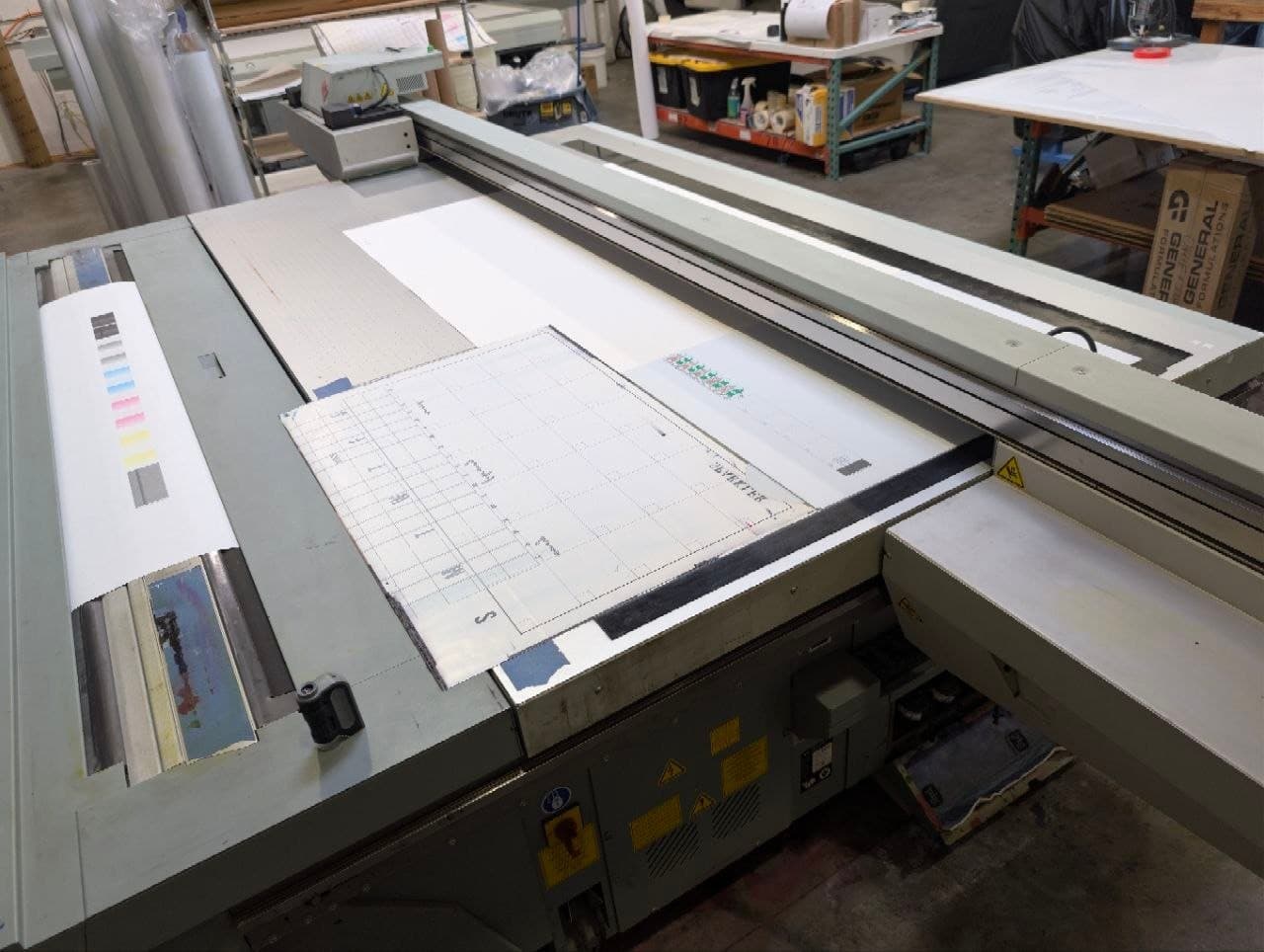 Printed alignment overlay lying on the vacuum bed of the Arizona 2280 against the registration ruler