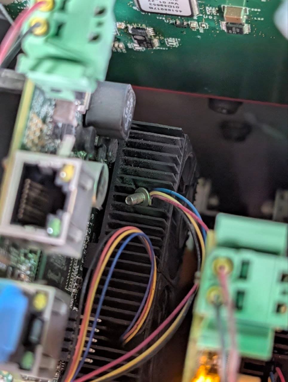 The loose screw where it came to rest, on a heatsink between the board connectors