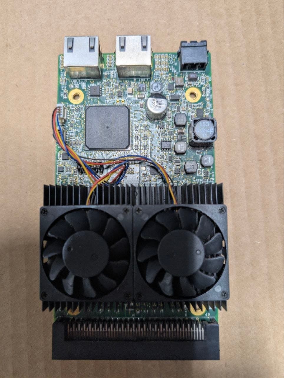 Second board off the machine, its twin-fan heatsink still fitted